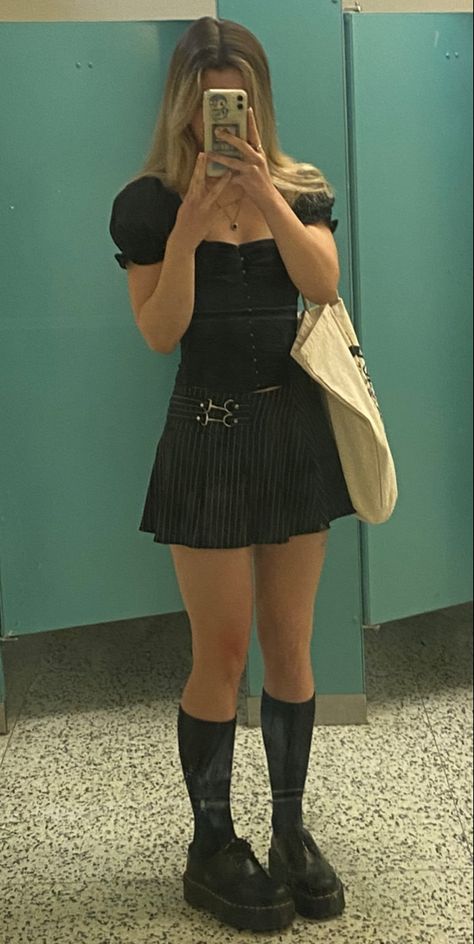 girl wearing puffy sleeve black top with black corset and vertical stripe skirt with clasp and black knee high socks and oxford low doc martens with tote bag mirror photo in a public washroom Mini Skirt Knee High Socks Outfit, Knee High Socks Outfit Grunge, Pin Stripe Skirt Outfit, Knee High Doc Martens Outfits, Black Knee High Socks Outfit, Knee High Doc Martens, Corset Skirt Outfit, Low Doc Martens, Doc Outfits