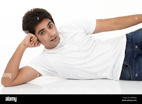 Download this stock image: Young man lying on side on the floor - WP9BNX from Alamy's library of millions of high resolution stock photos, illustrations and vectors. Laying Down On Side Pose, Lying On Side Pose Reference, Lying On The Floor Reference, Man Laying Down, Person Lying On The Floor, Lying Pose Drawing, Lie Down Pose, Laying On Side Pose, Laying On Side Pose Reference