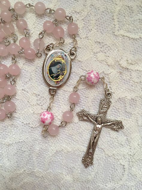 Handmade St. Rita of Cascia rosary beads made with 6mm pink Rose Quartz beads and 8mm ceramic pink & white floral beads. The center and crucifix are both made in Italy.