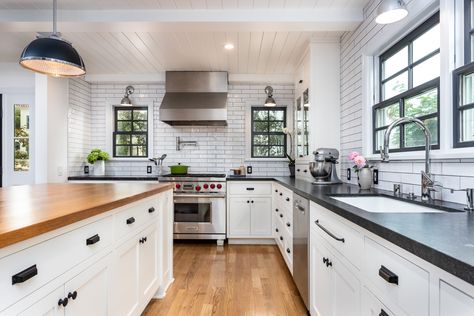 This gorgeous take on a Modern Farmhouse kitchen's features include shiplap ceilings, a butcher block island countertop, black grout on white subway tile, and hardwood flooring! Butcher Block Island Black Countertops, White Cabinets Black Granite Butcher Block Island, White Backsplash With Black Grout, Backsplash With Black Grout, White Cabinets Butcher Block Countertops, White Cabinets Black Granite, Shiplap Ceilings, Butcher Block Countertops Island, White Cabinets Black Countertops