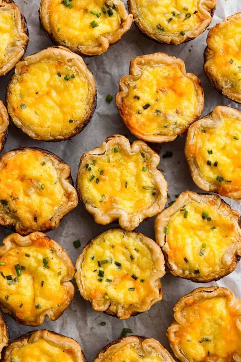 Bite-sized Mini Quiche are always a hit, and they're so easy to make! A creamy, flavorful ham and cheese egg filling bakes in a flaky pie crust for the most wonderful melt-in-your-mouth brunch treat. Serve these as hors d’oeuvres, a grab-and-go breakfast or a perfectly portioned snack and watch them disappear! Egg Quiche Recipes, Mini Quiche Recipe, Quiche Pie Crust, Mini Breakfast Quiche, Spinach And Eggs Breakfast, Quiche Bites, Breakfast Quiche Recipes Easy, Mini Pie Crust, Mini Quiche Recipes