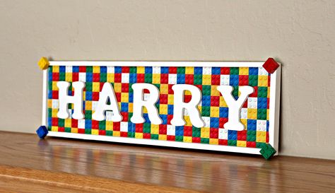 A personalized lego wooden child's name sign for display on a wall or door. This product is hand made with your child's name inside a wooden frame. Each letter is mounted on lego themed paper. Kids Room Sign, Diy Projects To Sell, Lego Craft, Kids Beds, Family Name Sign, Family Name Signs, Animal Hospital, Room Signs, Boy's Bedroom