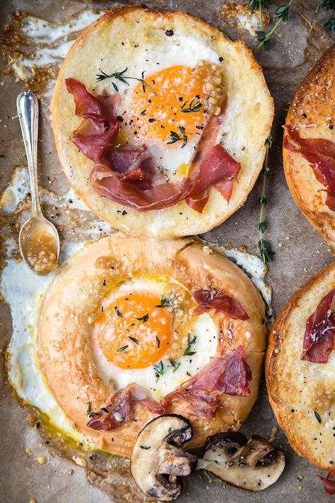 Sheet-pan baked eggs-in-a-hole with prosciutto and truffle pesto - delicious for breakfast, brunch or light lunch. Truffle Pesto, Bagels Easy, Sheet Pan Eggs, Egg In A Hole, Eggs And Bacon, Breakfast Bagel, Bacon And Eggs, Truffle Oil, Savory Breakfast