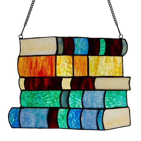 PRICES MAY VARY. This classic 7.5" High Stack of Books Stained Glass Window Panel from River of Goods features vibrant hues of Tiffany-style glass in orange, red, blue and green that bring this depiction of five hardcover tomes stacked high to life. Handcrafted from 30 individual glass cuts, this 7.5-inch-high stained glass panel is created using artisanal soldering methods. A metal link chain is included for immediate hanging, whether in a sunny living room, library or office. Any book lover wi Stained Glass Stack Of Books, Copper Foiling, Expo Ideas, Tiffany Style Lighting, Hanging Stained Glass, L'art Du Vitrail, Stained Glass Patterns Free, Glass Book, Stained Glass Window Panel