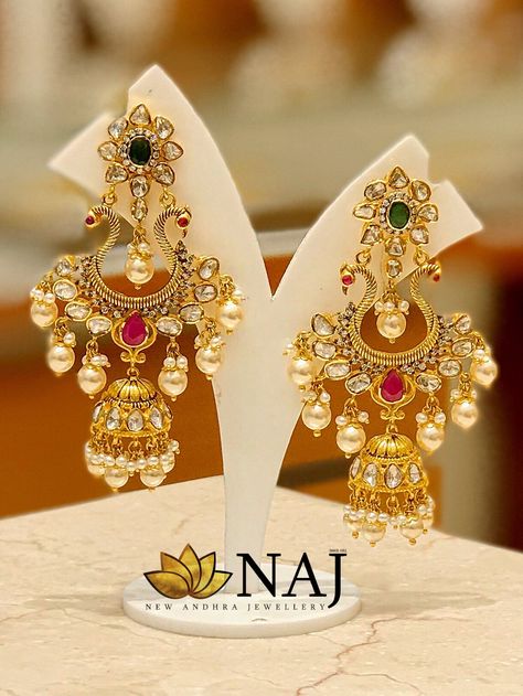 Stay in trend with this most beautiful Chandbali followed by a Jhumkas adorned with uncuts, ruby, emeralds & South sea pearls..Call or Whatsapp us on 9032041323 or email to mynaj@najindia.com... Available Only @ Naj Jewellery, Nellore.#TANAUSA, #TeluguUSA #uncuts #Jhumkas Naj Jewellery, Temple Jewellery Jhumkas, Luxury Jewelry Display, Temple Jewellery Earrings, Temple Jewelry Necklace, Gold Jhumka Earrings, Bridal Jewelery, Diamond Jewelry Earrings, Indian Jewelry Earrings