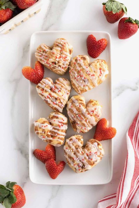 Heart Shaped Cinnamon Rolls Pillsbury, Valentine’s Day Cinnamon Rolls, Valentines Cinnamon Rolls, Heart Cinnamon Rolls, The Baker Mama, Shaped Cinnamon Rolls, Baker Mama, Heart Shaped Cinnamon Rolls, Heart Breakfast