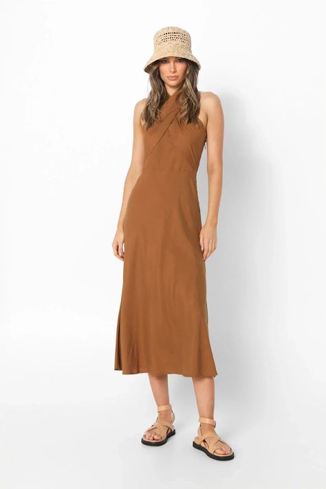 Lost in Lunar Santina Maxi Dress - Effortless Earthy Elegance Indulge in effortless style with the Lost in Lunar Santina Maxi Dress. This breezy brown linen blend dress is crafted from a comfortable 70% cotton and 30% linen fabric, perfect for warm days and balmy nights. Features: Flattering Silhouette: The relaxed loose fit drapes beautifully on all body types, offering all-day comfort and a touch of bohemian flair. Unique Design: The crisscross bust panels add a touch of visual intrigue, while the halter neck tie neckline creates a delicate and adjustable fit. Earthy Chic: The rich brown hue evokes a sense of natural elegance, making this dress perfect for a stroll on the beach, a summer picnic, or a night out. Earthy Chic, Linen Blend Dress, Polo Shirt Dress, Western Jeans, Youth Clothing, Baby Outerwear, Casual Dress Shoes, Romper Dress, Polo Dress