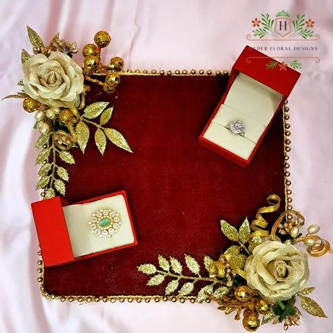 ✨ Red velvet Engagement Ring Platter ✨Celebrate love and commitment with our beautifully crafted engagement ring platter. elegantly crafted with Red Velvet, golden flowers, exquisite mirror work, and pearl accents. The arch above features a personalized golden acrylic laser-cut name, adding a unique touch to your special moment.this platter is designed to make your special moments unforgettable. Perfect for showcasing rings and adding a touch of sophistication to your engagement ceremony. ... Engagement Ring Platter, Ring Platter, Rings Ceremony, Engagement Ceremony, Instagram Gift, Floral Jewellery, Mirror Work, Bespoke Design, Special Moments