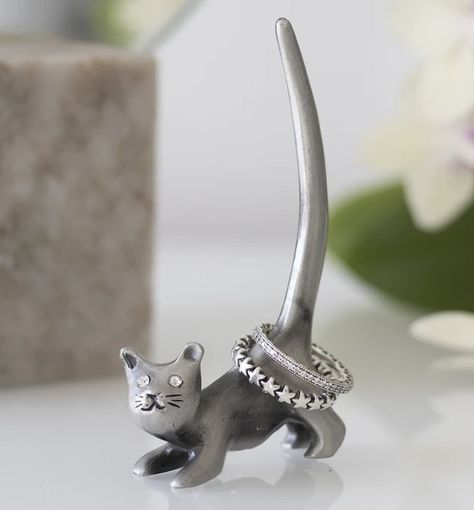 Metal Cat Ring Holder 🐈 £13.50 Free Postage ❤️ Keep rings tidy with this sweet ring holder shaped like a cat. Made of iron and makes an adorable decor piece on a vanity or dressing table. H9cm x W5cm x D2cm Elephant Ring Holder, Cat Ring Holder, Unusual Clocks, Christmas Presents For Her, Metal Cat, Sweet Ring, Iron Ring, Cat Ring, Animal Rings