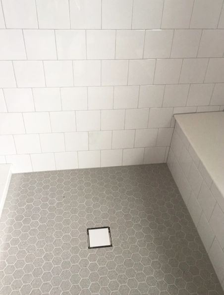 Gray Shower Floor Tile Ideas, White Square Tile Shower Wall, 6x6 White Tile Bathroom Shower Walls, White And Gray Tile Shower Ideas, Gray Hexagon Shower Floor, Grey Hexagon Shower Floor, White Shower Gray Floor, Gray Hexagon Tile Shower Floor, Gray Tile Shower Floor