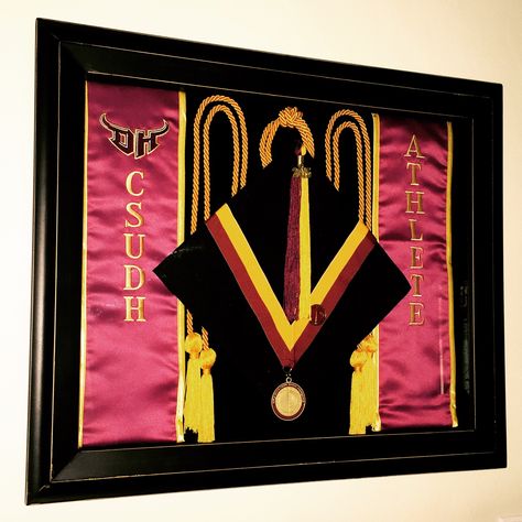 Pin your graduation cap, sash, tassel, cords, and medals to preserve them and display them. This beats using them once and storing them away in the closet to be forgotten. Use a shadow box about 16x18" with a foam backboard that will easily hold the pins. This shadow box was found at Michaels. Diploma Display Wall, Tassel Ideas, Graduation Regalia, Graduation Cords, Diploma Display, Graduation Display, Shadow Box Graduation, Grad Stoles, Graduation Frame