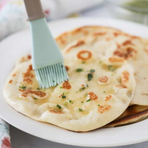 This homemade Indian Naan Bread is soft, bubbly, and so easy to make and a delicious side to all of your favorite Indian-style recipes.