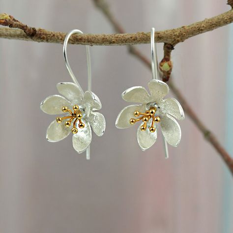 Beautiful water lily inspired earrings in satinized sterling silver with gold plated details on earring wires. These are my latest additions to the Flora and fauna collection. Size: 14 X 30 mm (drop)  All of my jewellery comes wrapped in tissue paper and packed in a pretty gift box.  My goal is to ship within 24 hours and if I cant I will let you know immediately. All orders going to the UK will be shipped Royal Mail 2nd class signed for and will arrive within 3 days. Shipments to Europe will... Sterling Silver Flower Earrings, Silver Gold Earrings, Silver Flower Earrings, Stylish Earrings, Earring Wires, Jewellery Inspiration, Alloy Earrings, Botanical Jewelry, Daisy Earrings