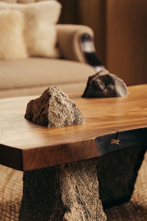 A new body of work from Oliver brings his skilled carving and deft combination of wood over stone into a pair of functional low tables. In each table, a Scottish timber surface is held in place over three rocks, pierced and anchored by gravity alone. There is heft and lightness, ritual and romance at play here. They echo standing stone circles and early altars. Otherlands - Table 01 brings together three craggy mountain stones of Oliver's Sutherland home. Together, they form a stone circle, captured by a piece of Scottish Elm. Through a slow process of placing, carving, checking and refining, the stones get locked into places using nothin more than the perfect cuts Oliver makes into the surface, using skills gained in his boatbuilding education. Oliver says: “The three rocks in each table Wood Stone Table, Wood And Stone Furniture, Wood And Stone Interior, Stone Furniture Design, Japanese Tables, Low Table Design, Rock Furniture, Tree Stump Side Table, Stone Furniture