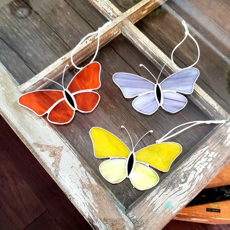 These stained glass butterfly sun-catchers are made in my home studio using beautifully colored stained glass. They look amazing in a window, hanging on a wall or suspended from the ceiling or out in the garden where the light can shine through. Perfect for the butterfly lover, or anyone who enjoys nature. Sold individually. It measures approx 5" x 2.5" Strung with white silky rattail cord so it can be hung immediately.  Polished to a brilliant shine and packaged with extra care to ensure safe t Stained Glass Butterfly Pattern, Butterfly Stained Glass, Glass Butterflies, Butterfly Suncatcher, Diy Stained Glass Window, Stained Glass Gifts, Glass Suncatchers, Rear View Mirror Decor, Stained Glass Ornaments