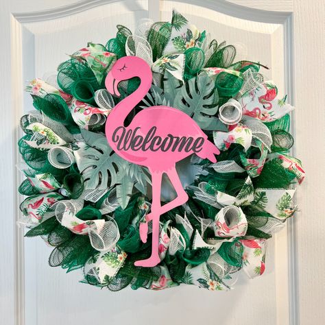 The flamingo wreath can be used any time of the year. It measures 20" in diameter and is 5" deep. This wreath is also available in pink. #flamingowreath Pink Flamingo Wreath, Flamingo Wreath, Beautiful Flamingo, Tropical Wreath, Wire Wreath Frame, Tropical Flamingo, Flamingo Decor, Different Shades Of Green, Welcome Wreath