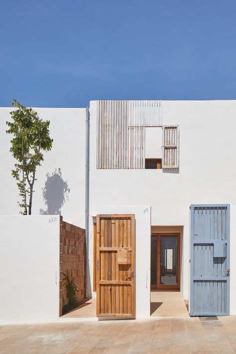 Carles Oliver, José Hevia · Formentera Social Housing Energy Efficient Buildings, Low Cost Housing, Wooden Shutters, Timber Door, The Proposal, Social Housing, Building Systems, Construction Cost, Building Exterior