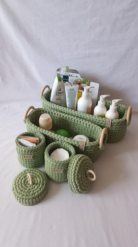 Bathroom storage practical set. 4 knitted baskets for storage. Organizers for cosmetics and cotton pads and sticks. Toiletries home storage. Elevate your home organization with our set of four hand-knitted baskets that blend functionality and style. These baskets are ideal for storing cosmetics, cotton pads, hygiene products, and skincare accessories. Features: - Functionality and Style:   Each basket has a unique design that is not only practical but also looks beautiful on any shelf or nightstand. - Perfect for Small Spaces:   Long, narrow baskets easily fit on any shelf, while the smaller baskets with lids provide dust protection and are perfect for storing small accessories. - Versatility:   Indispensable in the bathroom for storing personal items, they also perfectly complement the be Knitted Baskets, Baskets With Lids, Skincare Accessories, Baskets For Storage, Storage Baskets With Lids, Storage Organizers, Small Basket, Hygiene Products, Bedroom House