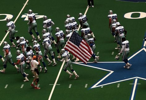 Dallas Cowboys safety George Teague, (31), carries an American flag onto the playing field at Texas Stadium in Irving, Texas, Sunday, Sept. 23, 2001 before kickoff with the San Diego Chargers. Texas Stadium, Irving Texas, Texas Flag, San Diego Chargers, Ncaa Football, Dallas Cowboys, Ncaa, American Flag, Soccer Field