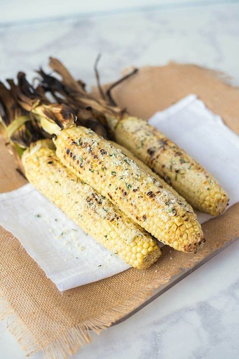 Grilled Parmesan garlic and basil corn on the cob is a delicious use of sweet, seasonal corn. Sweet corn on the cob is grilled then topped with fresh Parmesan, a butter made with roasted garlic and fresh basil for the best barbecue side dish. Grilling Vegetarian, Cob Recipes, Sweet Corn On The Cob, Grill Vegetables, Grilling Vegetables, Parmesan Butter, Grilled Corn Recipes, Grilled Vegetable Recipes, Recipes Gourmet