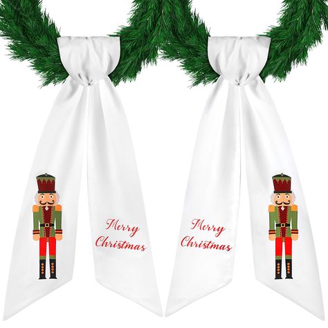 PRICES MAY VARY. Bring in the Holiday Cheer: you will receive 2 pieces of wreath sashes for front door; One side adorned with a classic Nutcracker pattern print and on the flip side, a [Merry Christmas] print, that leaves a lasting impression and amps up your holiday decoration Quality Material for Lasting Durability: the wreath sash for front door is constructed from polyester material; This provides a smooth, soft feel coupled with a durability that makes they'll be a part of your holiday deco Wreath Sash Pattern, Wreath With Sash, Sash For Wreath, White Nutcracker, Wreath Sashes, Nutcracker Pattern, Classic Nutcracker, Wreath Sash, Wreath Bows