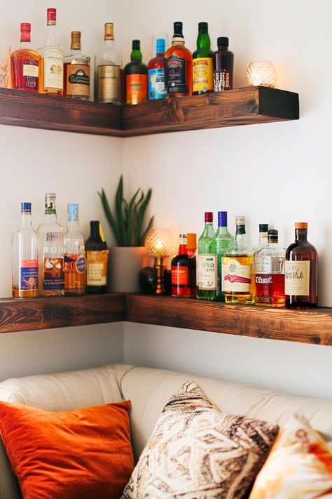 Struggling to find space for a home bar? Corner bar shelves are your answer! I love how these compact, multi-tiered shelves fit snugly into small spaces, transforming any unused corner into a cozy nook for your bar essentials. Perfect for small indoor bars or home liquor displays in living rooms or basements. Why not give your corner a functional and stylish makeover? Home Bar Display Ideas, Home Liquor Display, Liquor Bookshelf, Shelves For Bar Area, Small Bar Area In Basement, Floating Bar Shelves Ideas, Liquor Display Ideas Home, Alcohol Shelf Ideas, Bar Shelf Ideas For Home