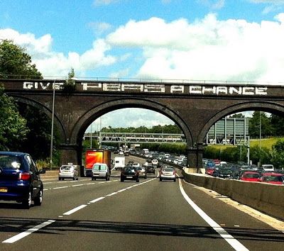 This is a bridge on the M25 motorway circling London, England. The graffiti reads "Give Peas A Chance" - obviously a John Lennon fan who can't spell. But a relevant message to these times - Give Peace a Chance! Give Peas A Chance, Great Western Railway, Night Moves, Listed Building, Great Western, Greater London, A Bridge, How To Level Ground, John Lennon