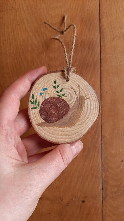 Hand Painted snail | Hanging Decoration | Wood Slice | Cottagecore wall decor | snail painting | bauble Snail Decor, Snail Painting, Painted Wooden Ornaments, Cottagecore Crafts, Cottagecore Wall Decor, International Christmas, Gouache Paints, Hand Painted Wooden Signs, Coaster Crafts