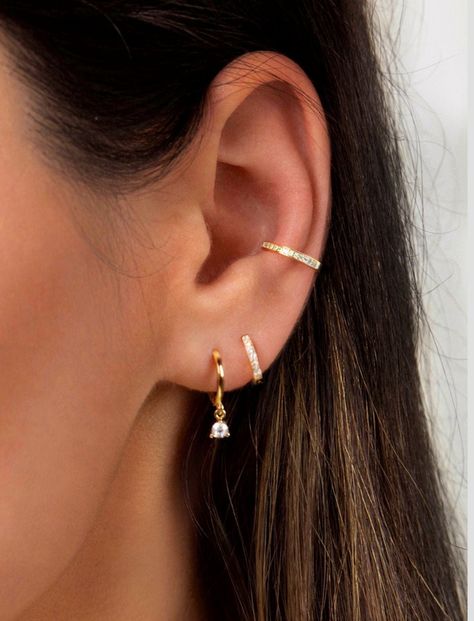 "Delicate and versatile, this skinny ear cuff is perfect to add a touch of sparkle to your ear without the need for a piercing. Half of the band is embedded with tiny pavé brilliant cubic zirconia gemstones and the other half is plain gold vermeil so that it can be worn in two different ways. Wear it with the little stones facing forward or the plain band facing forward - also looks stunning stacked as a pair for a statement look (as seen on model). ♦ Sold individually (1 ear cuff) or as a pair Tiny Gold Studs, Claw Earrings, Dainty Gold Earrings, Huggie Earrings Silver, Conch Earring, Bar Stud Earrings, Tiny Earrings, Huggie Earrings, Bar Earrings