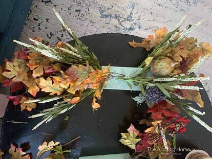 Creating a fall door swag is easy with my simple process. You will have one on your door in no time!I love celebrating the seasons by adding wreaths and swags to my door. This year I decided to put the swags on my stairs – it’s fun to do the unexpected. This fall door swag was simple to make and includes recycling old fall decor! You can see these beauties in all their glory in my fall home tour post, here. …and if you like the faux marble pumpkins, I created an easy tutorial. So,… Fall Door Swag, Diy Swag, Swag Ideas, Fall Swags, Fall Stem, Halloween Floral, Metal Pumpkins, Fall Home Tour, Swag Wreath