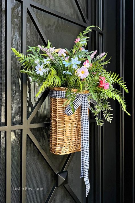 Spring Flowers Door Basket - See how to brighten up your front door with a simple wicker door basket full of pretty spring flowers. Spring Door Decoration. How To Make A Spring Door Basket With Flowers. Easy Spring Craft Project. Moss Wreath Diy, Front Door Baskets, Basket With Flowers, Spring Door Decoration, Wreath Alternative, Door Basket, Expensive Decor, Basket Wreath, Creative Wreaths