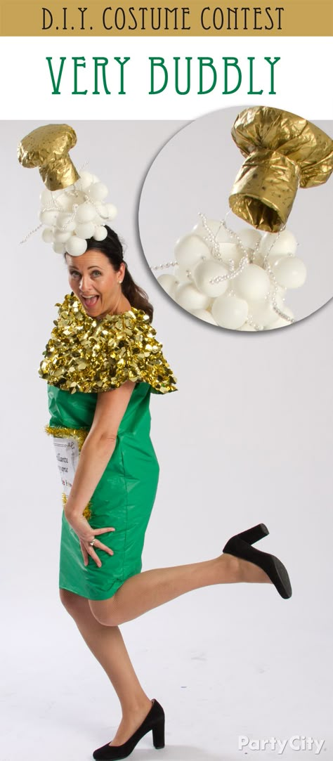 Clare’s champagne couture really *pops*! Her DIY champagne bottle costume is made from a green table cover and gold floral sheeting, and her fab fascinator is is a mix of small balloons, pearls on wire for “bubbles” and a “cork” made from gold tissue paper over bubble wrap. Mad glue gun skillz Clare! Champagne Problems Costume, Cocktail Costume Diy, Champagne Costume Halloween, Champagne Halloween Costume, Gold Costume Ideas, Diy Champagne Bottle, Kostüm Gold, Champagne Costume, Table Cover Diy