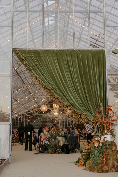 sage green velvet drapery and overgrown + organic floral installations for this eclectic greenhouse wedding reception Floral Print Wedding Dress, Hawaiian Wedding Dress, Greenhouse Venue, Green Wedding Decorations, Blue Green Wedding, Draping Wedding, Vintage Garden Parties, Greenhouse Garden, Greenhouse Wedding