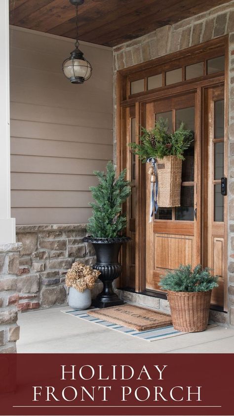 front door entryway with wood door and christmas hanging door basket with pine and cedar and pine tree in planter urn. Hanging Door Basket, Christmas Hanging Baskets, Front Door Baskets, Door Basket, Wreath Hangers, Front Door Wreaths, Front Entryway, Hanging Door, Christmas Front Doors