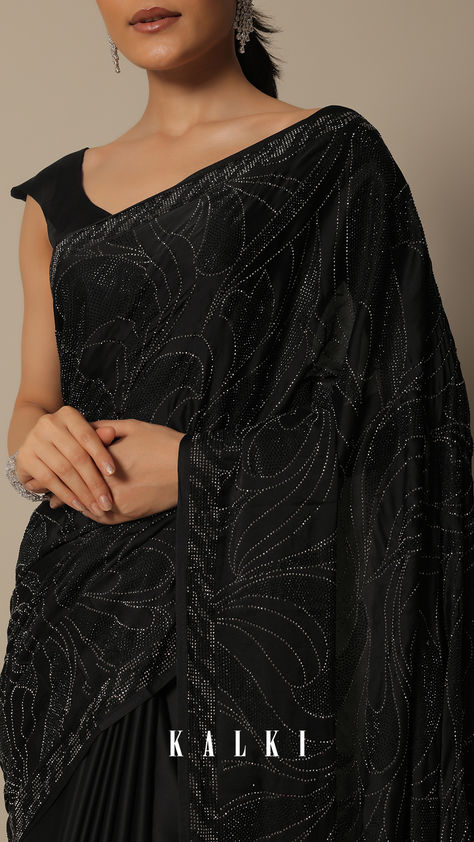 Embrace sophistication with our Swarovski Stone Studded Black Satin Saree. It is a captivating choice for cocktail and party wear. This embellished saree, in classic black satin, is adorned with intricate detailing. Paired with an unstitched blouse, this set ensures you radiate glamour at festive celebrations. Designer Black Embellished Saree, Luxury Black Embellished Saree, Elegant Black Embellished Pre-draped Saree, Festive Black Semi-stitched Pre-draped Saree, Festive Black Embellished Pre-draped Saree, Embellished Saree, Kalki Fashion, Satin Saree, Swarovski Stones