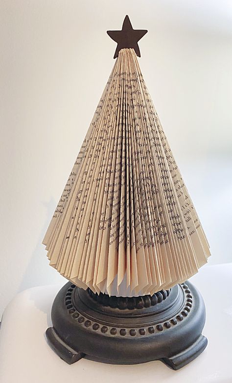 DIY book page trees with pedestal bases Vintage Book Christmas Tree, How To Make An Angel From A Book, Christmas Tree Folded Book, Book Christmas Trees Diy, Crafts With Old Books Pages, Christmas Tree Made From Book Pages, Book Pages Crafts Christmas, Snowman Made From Books, Folded Book Christmas Tree How To Make