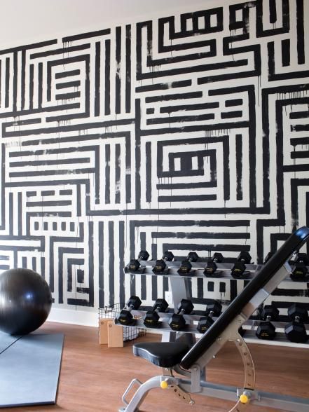 An energetic focal wall and top-of-the-line exercise equipment create a motivational environment for cardio and strength training. Home Gym Wallpaper, Exercise Rooms, Dream Home Gym, Gym Wallpaper, Diy Home Gym, Spin Bike, Fitness Plans, Diy Gym, Exercise Room