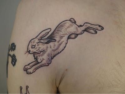 Rabbit Back Tattoo, Irish Hare Tattoo, Jumping Rabbit Tattoo, Hare Tattoo Design, Lucky Rabbit Tattoo, Rabbit Art Tattoo, Jack Rabbit Tattoo, Rabbits Tattoo, Running Rabbit Tattoo