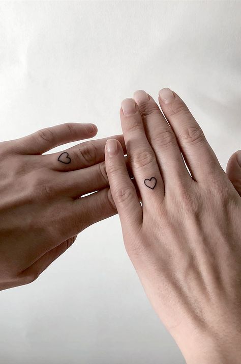 Tattoo For Couples Who Don't Need An Engagement Ring To Seal Their Love.  How do you prove your love to your significant other?   Couples marriage ring tattoos to prove your love. Marriage Ring Tattoos, Tattoo For Couples, Herz Tattoo Klein, Unique Infinity Tattoo, Marriage Tattoos, Infinity Couple Tattoos, Wedding Band Tattoo, Tattoos For Couples, Heart Couple