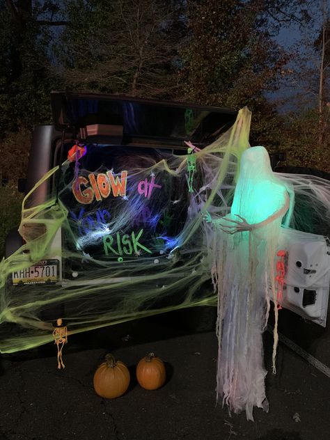 Glow themed trunk for trunk or treat! Had glow necklaces and let the kids play ring toss with them on the pumpkins. Used black light paint on a black sheet for the saying. Kids loved it! Trunk Or Treat Black Light, Glow Trunk Or Treat, Glow Party Trunk Or Treat, Glow In Dark Trunk Or Treat, Trunk Or Treat Glow Theme, Trunk Or Treat Glow In The Dark, Black Light Trunk Or Treat, Glow Stick Trunk Or Treat, Glow In The Dark Trunk Or Treat