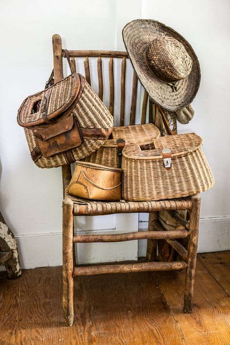 We're better at fishing for vintage creels (also known as fisher- men's baskets) than casting a line for what they were designed for. Piled onto an old twig chair, they're an easy spot to stash miscellaneous caps and scarves.   - CountryLiving.com Fishing Creel Decor Vintage, Fishing Basket Ideas, Victorian Scenery, Twig Chair, Fish Decoys, Door Hallway, New Kitchen Gadgets, Fishing Cabin, Fishing Basket