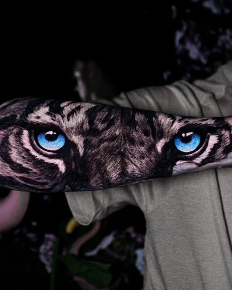 Black and grey tigers eyes tattoo on forearm with blue eyes. White Tiger Blue Eyes Tattoo, Upper Arm Tiger Tattoo Men, Tiger With Blue Eyes Tattoo, Blue Eyes Tattoo, Tiger Eye Tattoo, Head Tattoo Ideas, Tiger Tattoo Thigh, White Tiger Tattoo, Queen Tattoo Designs