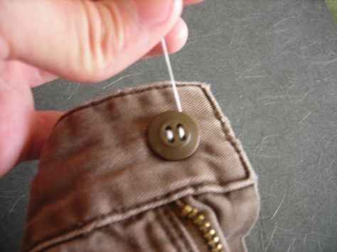 Sewing a button onto pants is not very difficult but there are some nuances.  Knowing these sewing nuances will prevent you from doing the work of a runny nosed amateur. This article will show you how to put a button on pants. You'll be a tailor in... Sew A Button, Sewing Pants, Sewing Circles, Make Do And Mend, Handy Dandy, Sewing Skills, A Button, How To Sew, Sewing For Beginners