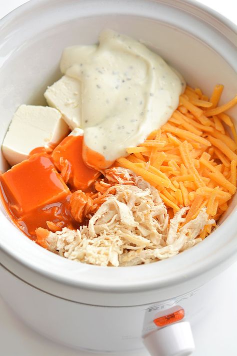 This recipe for crockpot buffalo chicken dip made with real chicken is SO GOOD and it's so easy to make! With only 5 simple ingredients, you can set it on in the crockpot and it will be ready when you need it. This is such an easy appetizer recipe and a delicious recipe for game day. Served with nachos, crackers or veggies, it's a perfect Superbowl snack... or anytime party snack! Crockpot Chicken Wing Dip, Chicken Crockpot Dip, Buffalo Chicken Crockpot, Crock Chicken, Crockpot Dip, Crockpot Buffalo Chicken Dip, Superbowl Snack, Mini Crockpot, Wing Dip