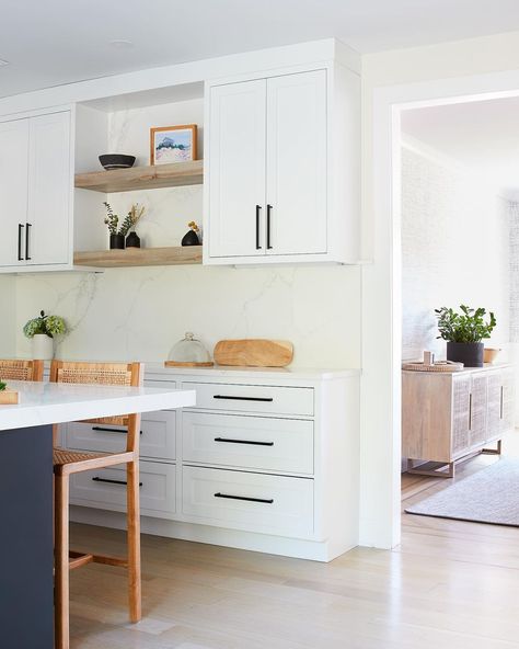 Kitchen White Cabinets With Black Handles, White Flat Panel Kitchen Cabinets Black Hardware, White Kitchen Black Hardware Gold Pendant Lights, All White Kitchen Black Hardware, Hardware For White Shaker Cabinets, White Kitchen Hardware Ideas, White Kitchen Cabinets Black Hardware, Dark Blue Kitchen Island, White Flat Panel Kitchen Cabinets