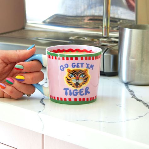 Mugs – Eleanor Bowmer Eleanor Bowmer, Go Get Em Tiger, Go Get Em, Pastel Pink Background, Tiger Illustration, Go For It, The Tiger, Green And Red, Red Stripe