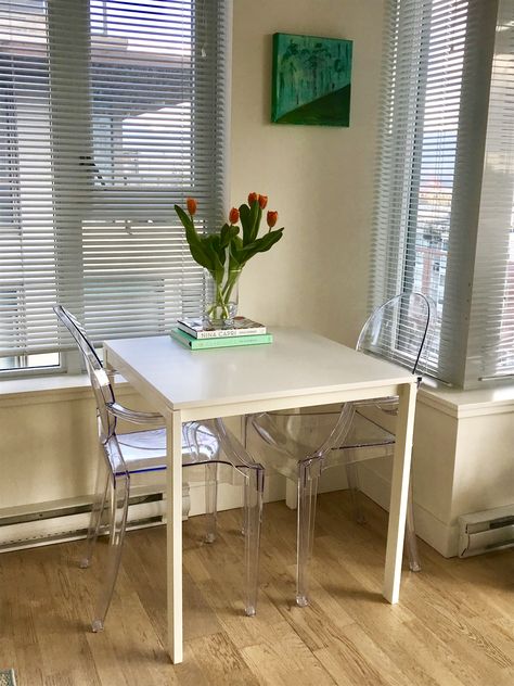 New table and chairs.. great for a small space and the ghost chairs help to brighten the space too #ApartmentDecor #ghostchair #smallspace #clean #ikea #diningroom #diningchair #flowers #coffeetablebooks #cookbook #claridges #ninacapri #tulips #art #melltorp Melltorp Ikea, Ikea Diningroom, Ikea Melltorp Table, Melltorp Table, Ikea Dining Table, Clear Chairs, Cute Apartment, Ghost Chairs, Tulips Art