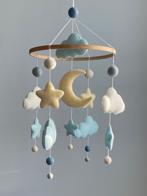 This cute felt balls mobile with stars and clouds are ideal as a décor for a children's room. These handmade mobiles add that perfect final touch to your new little one's nursery. Gorgeous, delicate and light crib mobile will for sure be the focal centerpiece of your nursery or any other room in your house . This  felt ball mobile is perfect decoration for a baby boy or girl nursery room. It will surely become a wonderful design item in your kid's room. Baby mobile is first wonderful present for Crib Mobile Boy, Space Mobile, Crib Decoration, Felt Baby Mobile, Pom Pom Mobile, Stars Baby Mobile, Moon Mobile, Handmade Mobile, Boy Mobile