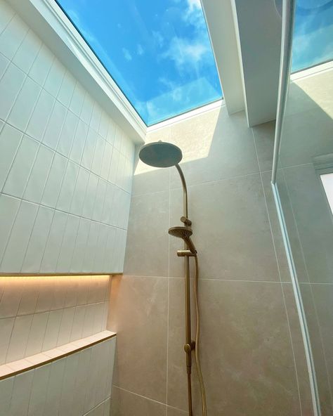 Reaching for the sky ⛅ Want to shine some light into your bathroom makeover? Take a look at this bathroom inspo created using the OmniStone Beige Silk Tile and Agrestic White Satin Tile paired with the Misty Grey Grout and Matt Gold Trim #beaumonttiles #ichosebeaumont #skylight #shower Shower Sky Light, Bathroom Sky Light, Sky Light Bathroom, Bathroom Skylight, Shower Skylight, Reaching For The Sky, Indoor Outdoor Bathroom, Grey Grout, Outdoor Bathroom