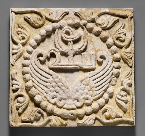 Wall panel with wings and a Pahlavi device encircled by pearls  Period: Sasanian Date: ca. 6th century A.D. Geography: Mesopotamia, Ctesiphon Culture: Sasanian Medium: Stucco Dimensions: H. 15 3/8 x W. 16 1/4 in. (39 x 41.3 cm) Persian Symbols, Chinese Drawing, Iranian Architecture, Persian Architecture, Middle Eastern Culture, Ancient Persia, Persian Empire, Persian Motifs, Persian Culture